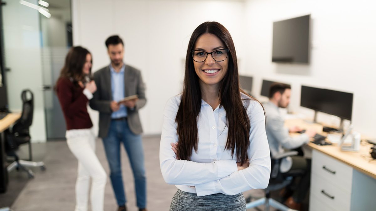 portrait-of-young-businesswoman-posing-in-office-WEU5FBG